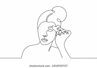 A woman massages the area around her eyes using a gua sha board. Treatment against swelling, bags under the eyes and expression lines. Images produced without the use of any form of AI. 