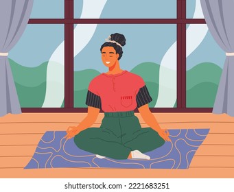 Woman meditating at home sitting in yoga posture on floor next to big window, doing relaxation exercises. Concept for yoga, meditation, relax, recreation, healthy lifestyle, girl in lotus position