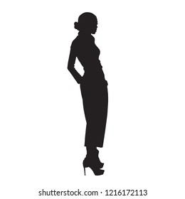 Woman model standing in high heels shoes, posing female model in trousers with hands in pockets. Isolated vector silhouette