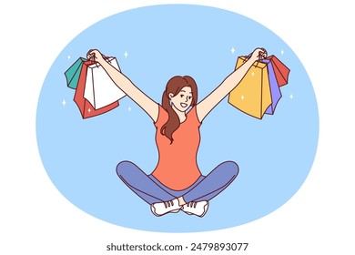 Mujer con paquetes multicolores de las tiendas de ropa se sienta con los brazos separados después de comprar con éxito. La chica que ganó la lotería de compras muestra las cosas compradas con un gran descuento o reembolso