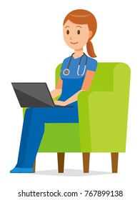 A woman nurse wearing a blue scrub is sitting on a sofa and operating a laptop computer