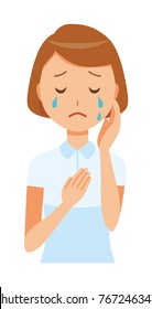 A woman nurse wearing a white uniform is crying