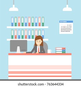 Woman in the office sitting at the desk and working.