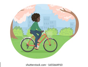 Woman on bike. Cycling african woman in the spring city park. Bicycle with basket. 