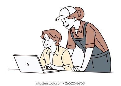 A woman in overalls and a cap stands behind a person using a laptop, both smiling and engaged in a shared task.