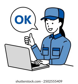 Woman in overalls working on a laptop making an OK sign