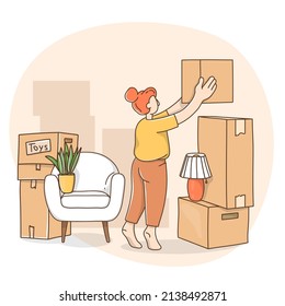 Woman packing things in boxes while moving to a new house.