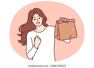 Woman with paper bag making victory gesture demonstrating food ordered from restaurant with delivery. Takeaway package for food or drinks in hand of girl delighted with purchase of delicious lunch