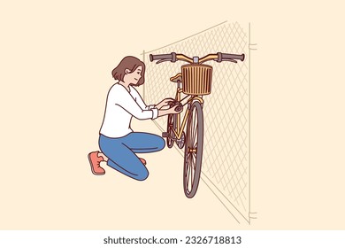 Woman parks bicycle near fence after returning from work on environmentally friendly transport. Concept caring for nature and rejection of cars with internal combustion engine in favor of bicycle