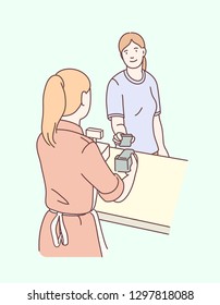 Woman paying with phone, sales clerk holding wireless payment terminal at checkout counter. Customer making contactless payment with mobile smartphone. NFC technology. Flat line vector illustration