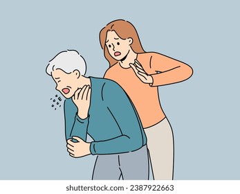 Woman performs heimlich maneuver for choking old man who needs help due to airway obstruction. Sick human choked on food and coughed standing near girl ready to do heimlich maneuver