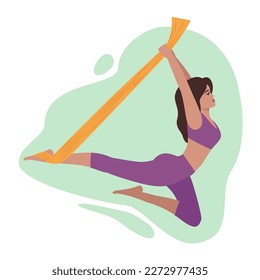 A woman performs a yoga asana hanging in a hammock, flying yoga. The concept of a healthy lifestyle, air gymnastics, fly yoga.