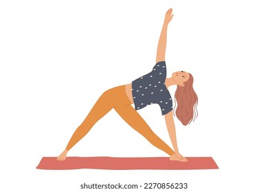 Woman performs yoga exercises by bending to the side and raising her hand - a triangle pose, three corners or Trikonasana.