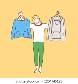 A woman is picking up two kinds of clothes. hand drawn style vector design illustrations.