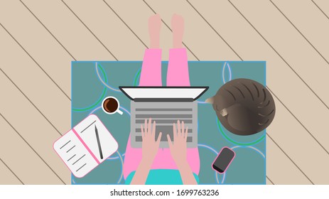 a woman in pink pants sits on a blue rug and works at a laptop, a brown striped cat sleeps nearby, a pink mobile phone lies, an open notebook with a pencil and a white cup with coffee