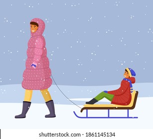 Woman in pink warm down jacket and boots rides girl in red warm jacket, scarf on sled. Snowflakes, snowfall, winter time. Games on the fresh frosty air. Mom and daughter. White snow background