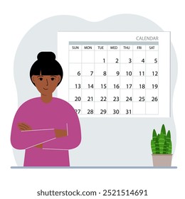 A woman plans his schedule, meetings for a month, holidays, weekends and important dates. Time management and optimization. Big calendar and a woman.