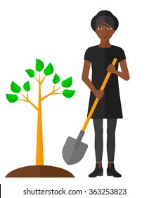 Woman plants tree.