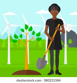 Woman plants tree.
