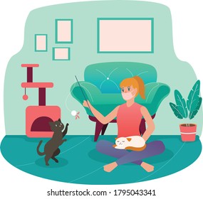 A woman playing with her cat while using medical mask