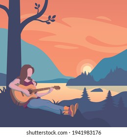 A woman plays a guitar at sunset. Relaxing atmosphere of mountains and lakes at sunset.