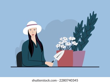 Woman and potted flowers sitting at the desk at her working place. Asian female gardener.