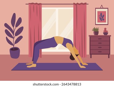 Woman practicing yoga at home. Female doing wheel pose on mat. Healthy lifestyle and fitness routine for recreation. Self-care and wellbeing.