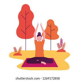 woman practicing yoga on mat in the park