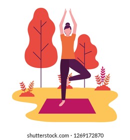 woman practicing yoga on mat in the park