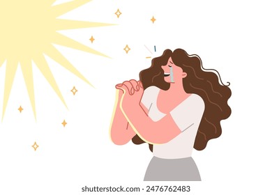 Woman prays with tears in eyes and rejoices at miracle she has seen, standing near bright flash in sky. Believing girl cries and prays thanks to lord for fulfillment of wish or remission of sins