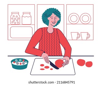 Woman prepares a salad and cuts a tomato with a knife