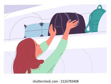 A woman pulls her bag from the top shelf after her flight