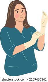 A woman puts on medical gloves.