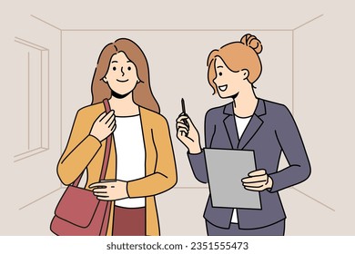 Woman real estate agent or realtor shows apartment to girl to client and offers conclude contract. Process showing house to realtor and entering into lease or sale agreement with mortgage