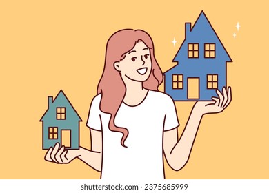 Woman realtor holds two houses offering to choose property she likes and arrange mortgage or rent. Happy girl chooses house or apartment for mortgage in bank and looks at screen smiling