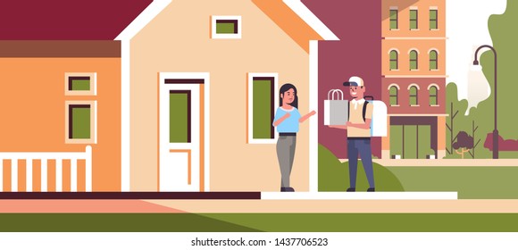 woman receiving order from man courier in cap with backpack and paper package express food delivery from shop or restaurant concept modern house building exterior flat horizontal full length