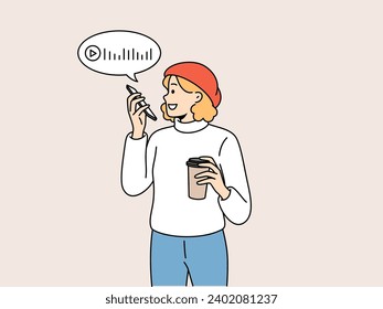 Woman is recording voice messages holding phone and plastic glass of coffee in hands. Beautiful girl uses voice messages to communicate with friends via internet or post on social networks