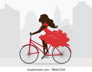Woman in red dress rides bicycle on background of city.