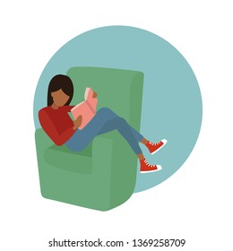 Woman with red T-shirt, jeans and red sneakers reading sitting on the green armchair. Relaxing time on the sofa.