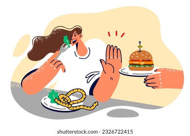 Woman refuses hamburger and eats healthy food, wanting to get rid of excess weight and lead healthy lifestyle. Girl with plate filled with salad makes stop gesture refusing to eat fast food