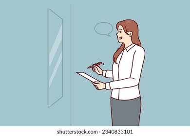 Woman is rehearsing motivational speech standing in front of mirror and learning oratory and persuasive skills. Businesswoman with pen and piece of paper rehearsing presentation speech for conference