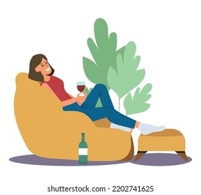 woman relaxing on a puff holding a glass of wine, young woman resting in her spare time.