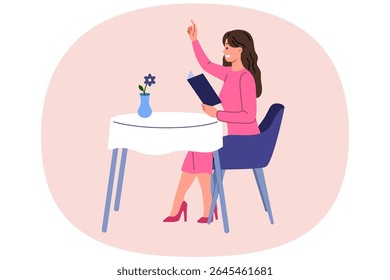Woman restaurant visitor raises hand to call waiter and place order, sits at table and holds menu. Girl guest at elite restaurant enjoys cozy atmosphere and opportunity to eat gourmet cuisine.