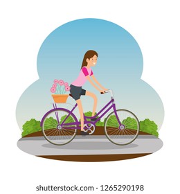 woman in retro bicycle with floral basket on road