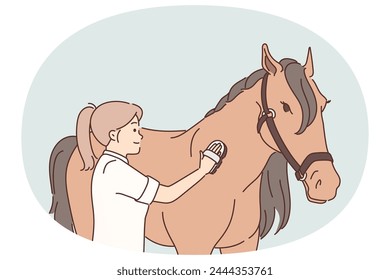 Woman rider takes care of thoroughbred horse by combing animal mane before important races. Girl rider strokes thoroughbred horse using comb for grooming and is fond of breeding equine