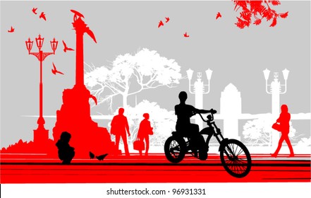 a woman rides a bicycle on the area near the monument