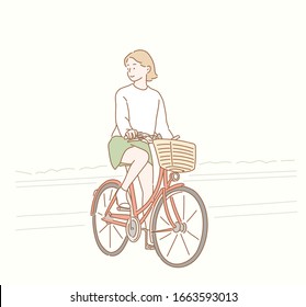 Woman riding a bike. Hand drawn style vector design illustrations.