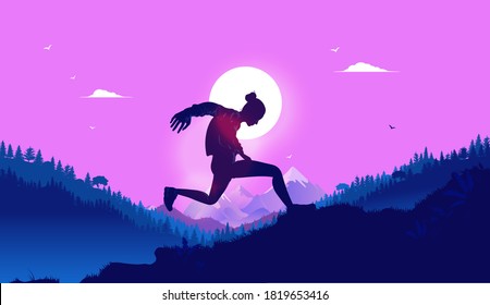 Woman running up hill - Silhouette of female person jumping up a hill outdoors in front of sun with nature and mountains in background. 
