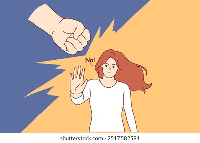 Woman says no to domestic violence and makes stop gesture, standing near fist of wants to strike. Girl resists domestic violence, wanting to get rid of toxic relationships and beatings