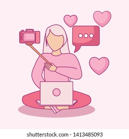 woman seated using laptop computer with photographic camera
